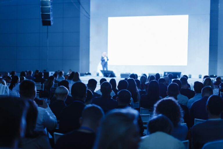 Audience and speaker on stage at conference